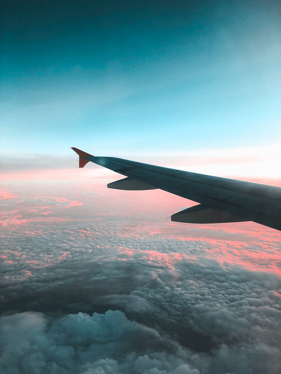 view of airliner wing above the clouds