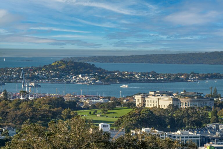 Scenic view of Auckland Museum, harbor, and city skyline on a clear day.