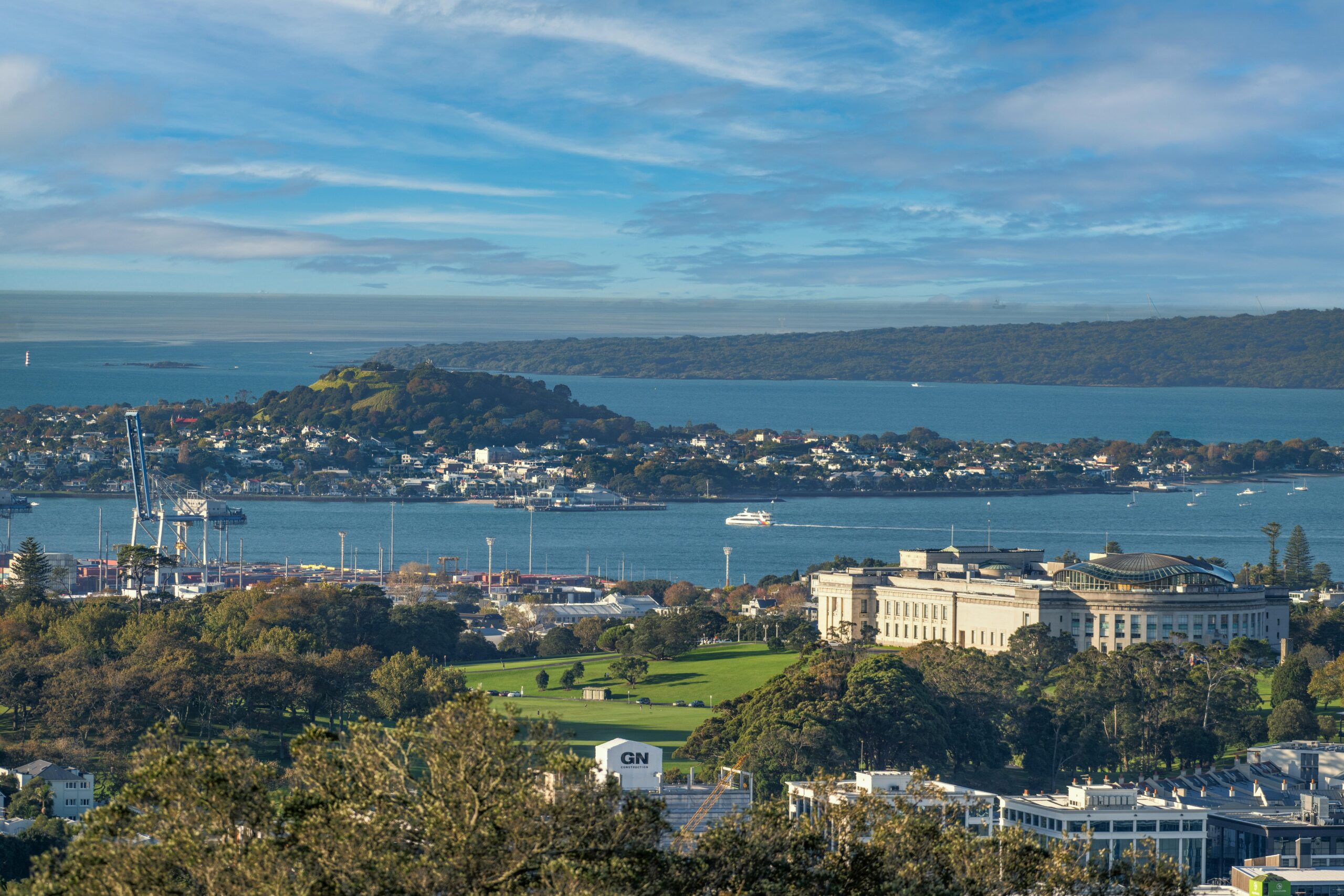Scenic view of Auckland Museum, harbor, and city skyline on a clear day.