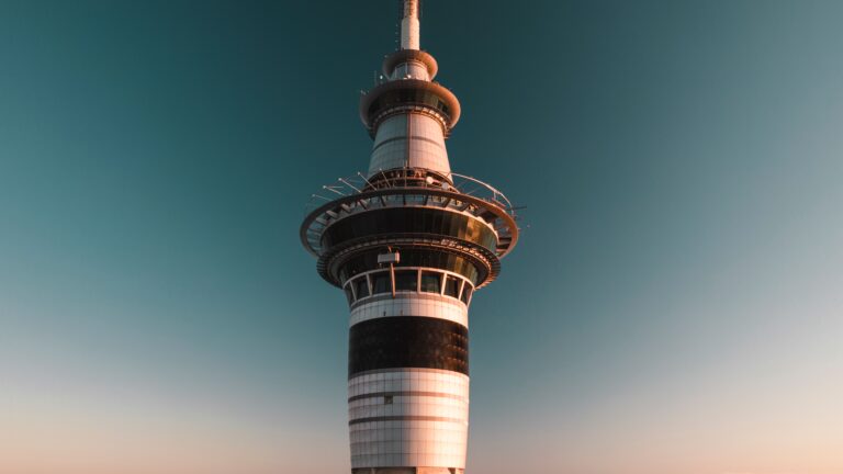 Photograph of the iconic Sky Tower in Auckland, New Zealand against a clear sky at sunset.