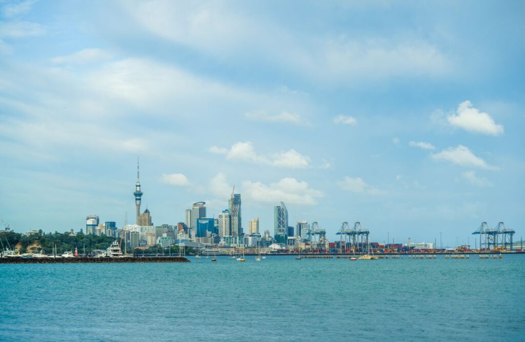 Stunning view of Auckland's skyline with boats in the harbor under a clear blue sky.